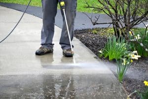 Person uses power washer